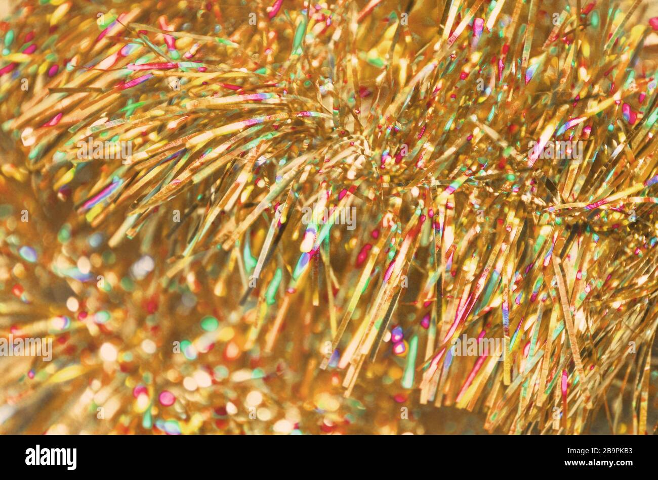 Christmas golden garland. Party celebration texture. Colorful  gold Christmas tinsel. Merry Christmas and happy New Year  background Stock Photo