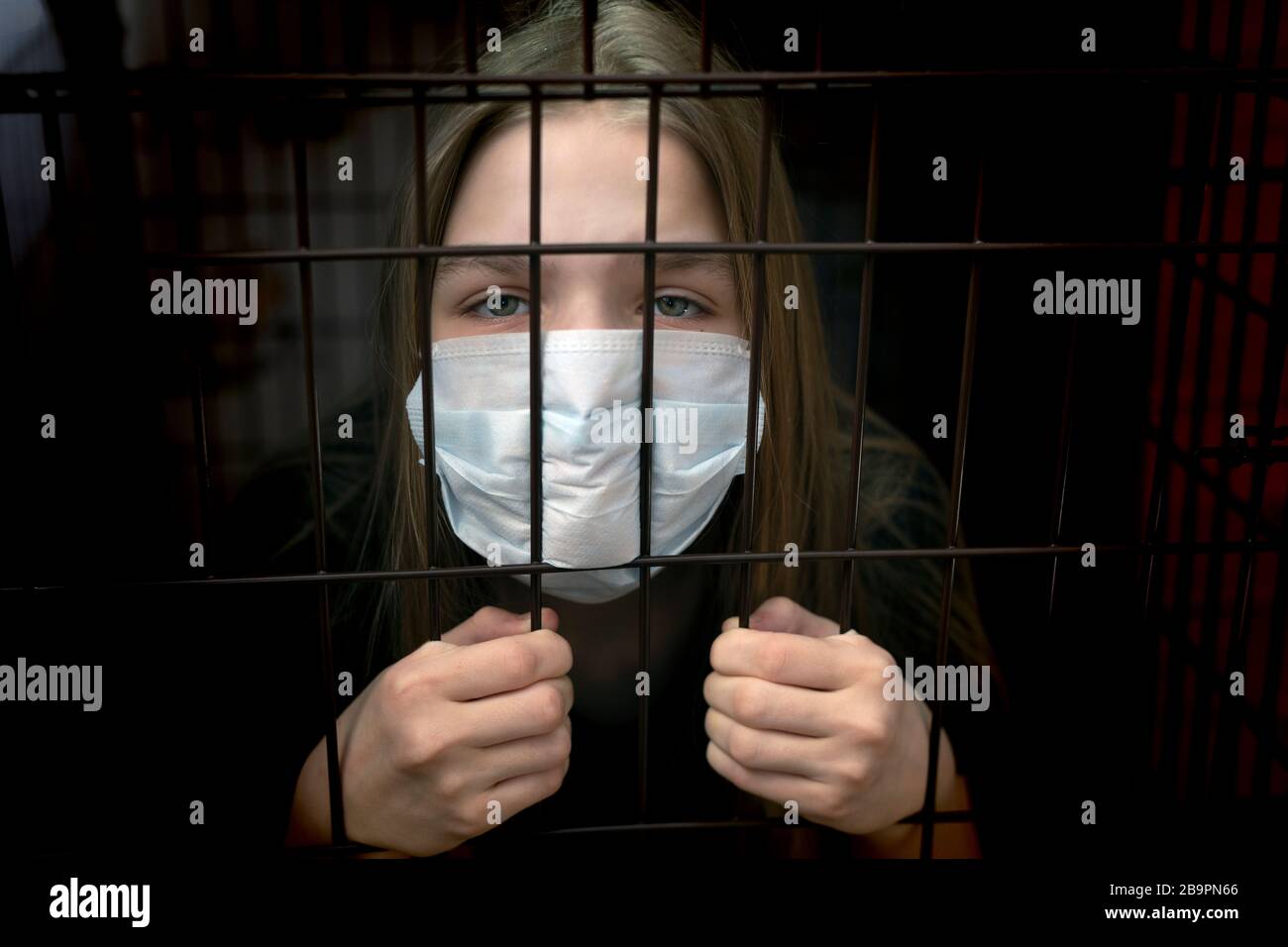 Young unhappy girl imprison at home for protection corona virus. coronavirus and epidemic virus symptoms Stock Photo