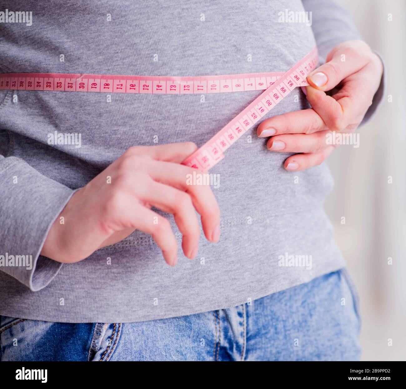 The pregnant woman measuring belly with centimeter Stock Photo Alamy