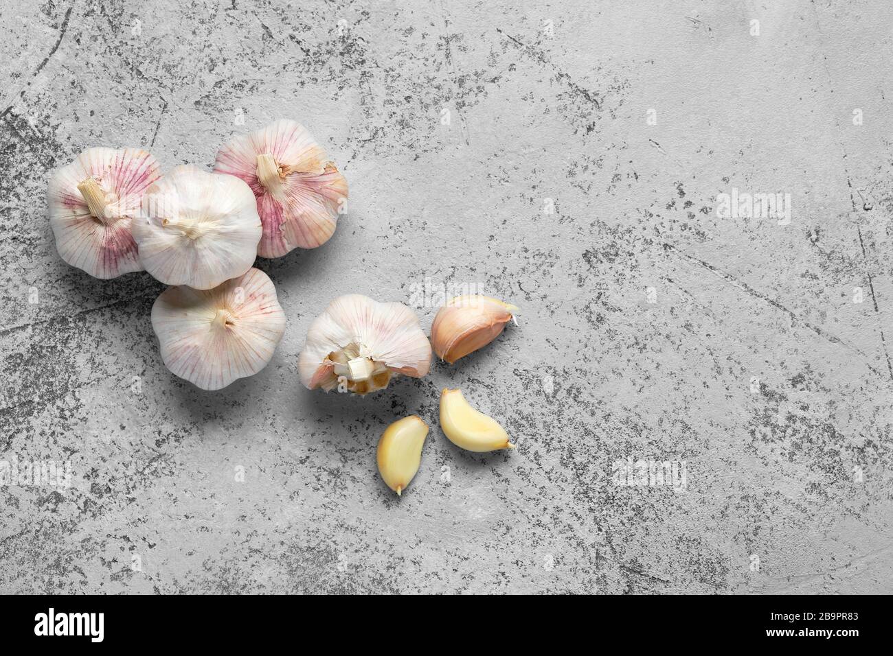 Top view of garlic cloves and bulbs on wooden cutting board Stock Photo ...