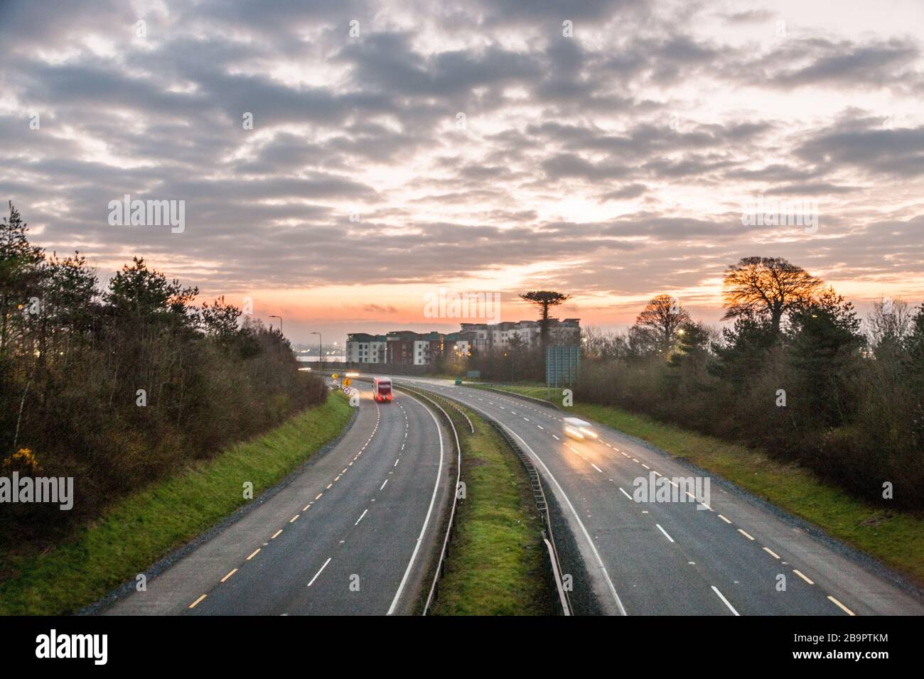 Mahon, Cork, Ireland. 25th March, 2020. With the Irish Government announcing a raft of new measures to limit movement in the fight against Covid-19, including the closure of all non essential retail stores . Picture shows early morning rush hour traffic that was extremely light on the N40,  which is one of the main national  roads into and out of the city at the junction for Mahon in Cork, Ireland.  - Picture; David Creedon / Anzenberger Stock Photo