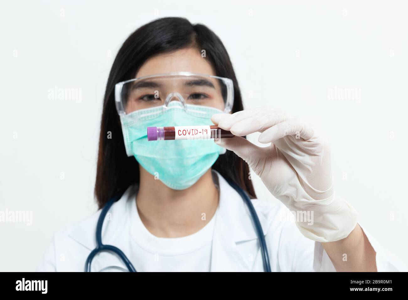 Coronavirus blood sample. Asian doctor holding test tube with blood for covid-19 analyzing. laboratory analyzing for testing and invent drug and vacci Stock Photo