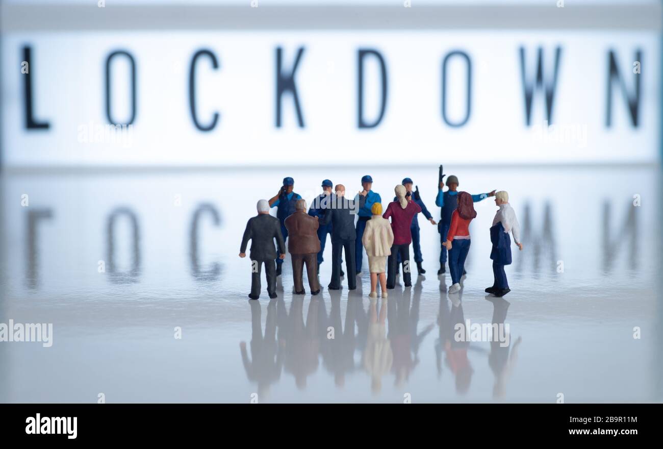 Movement control orders (mco) lockdown concept images - miniature toy figures of police or border patrol officers stopping public from entering due to Stock Photo
