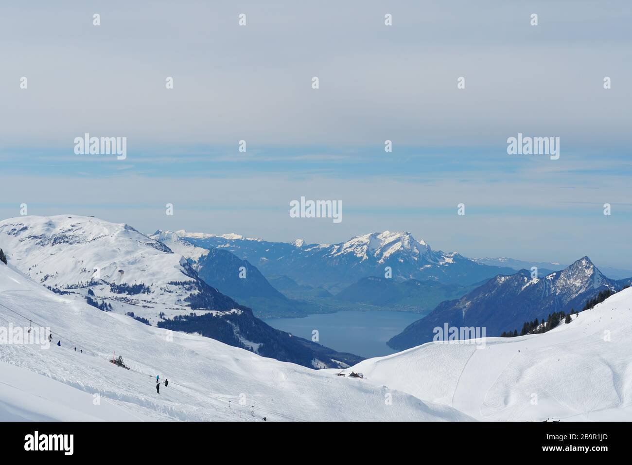 Skiing slopes of Hoch Ybrig skiing resort Switzerland with view on Lake Lucerne and panorama of Alps. Stock Photo