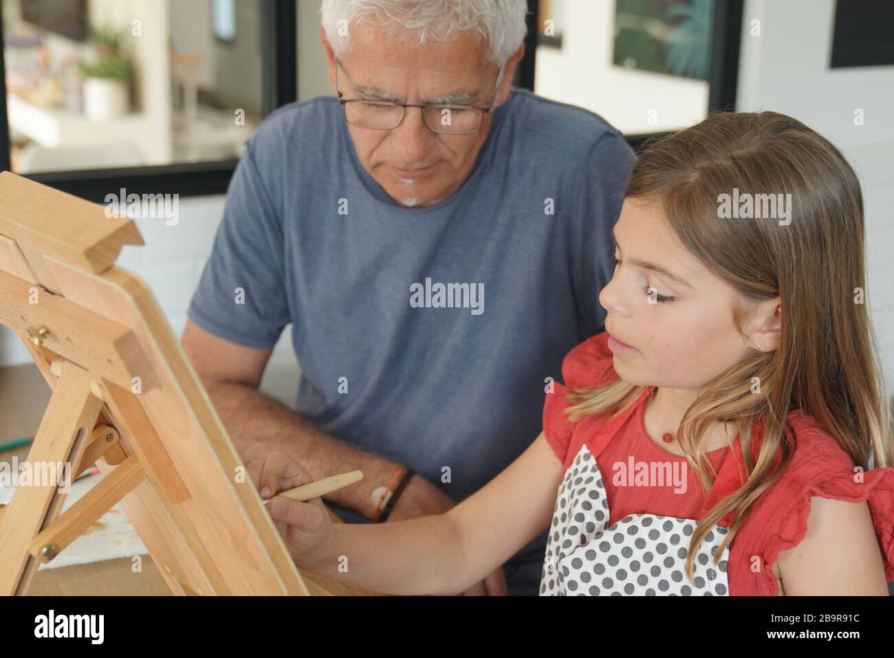a father with his daughter painting Stock Photo Alamy