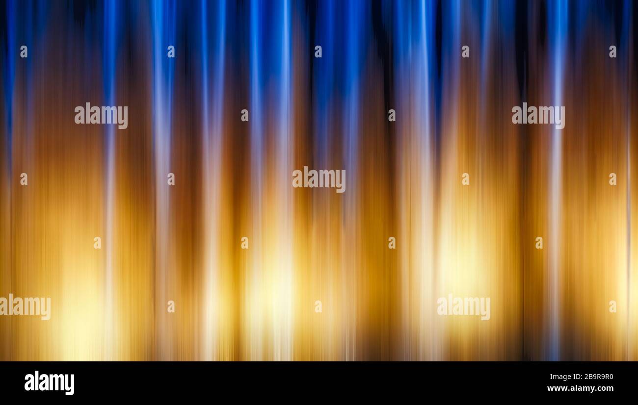Abstract blue and yellow light trails in the dark background, motion ...