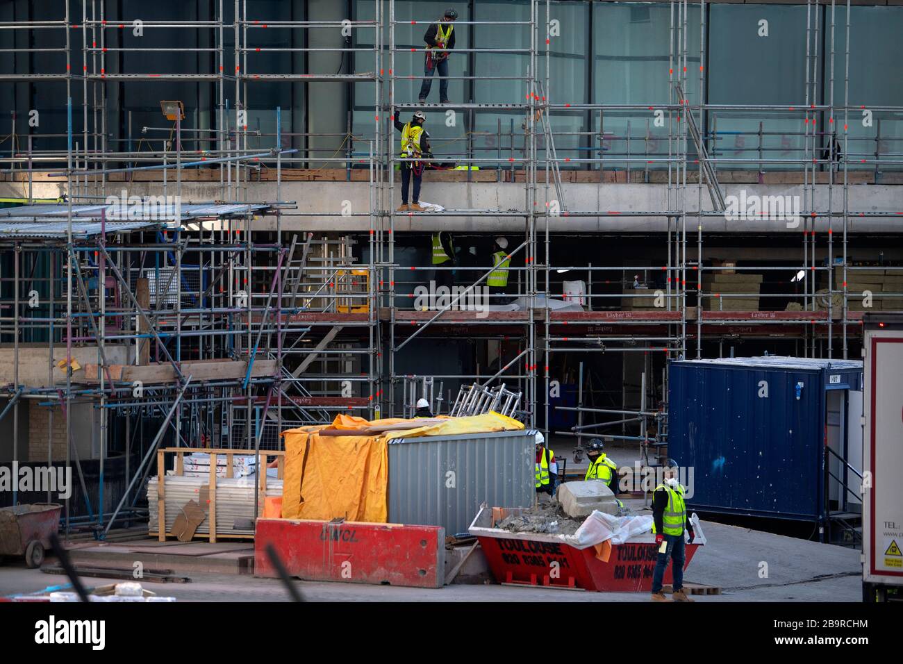 Construction workers on a residential building in Canary Wharf, after Prime Minister Boris Johnson has put the UK in lockdown to help curb the spread of the coronavirus. Stock Photo