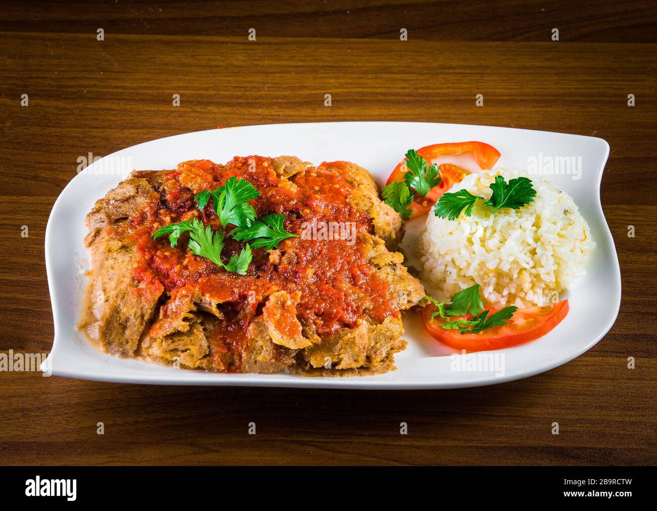 Traditional Turkish iskender kebap doner served with special red sauce