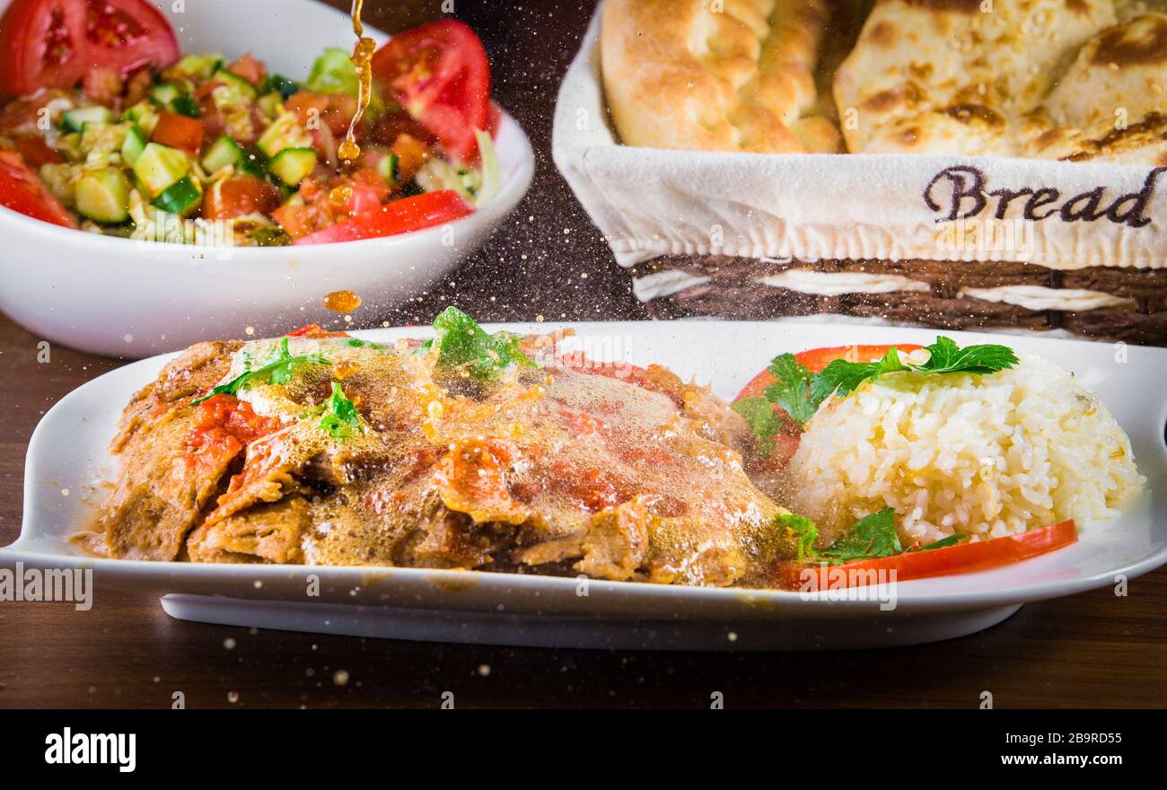 Traditional Turkish iskender kebap doner served with special red sauce
