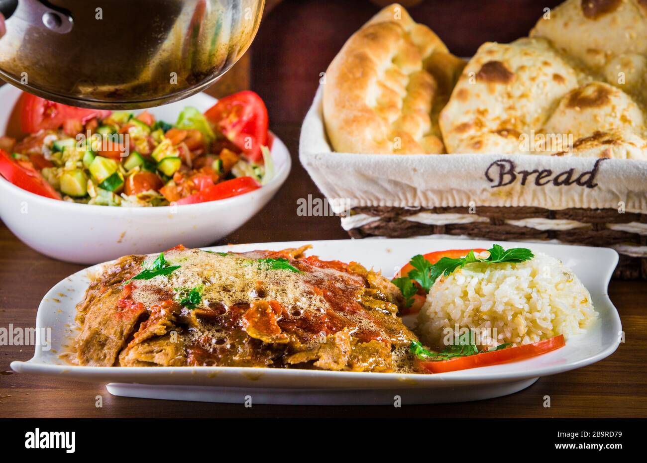 Traditional Turkish iskender kebap doner served with special red sauce