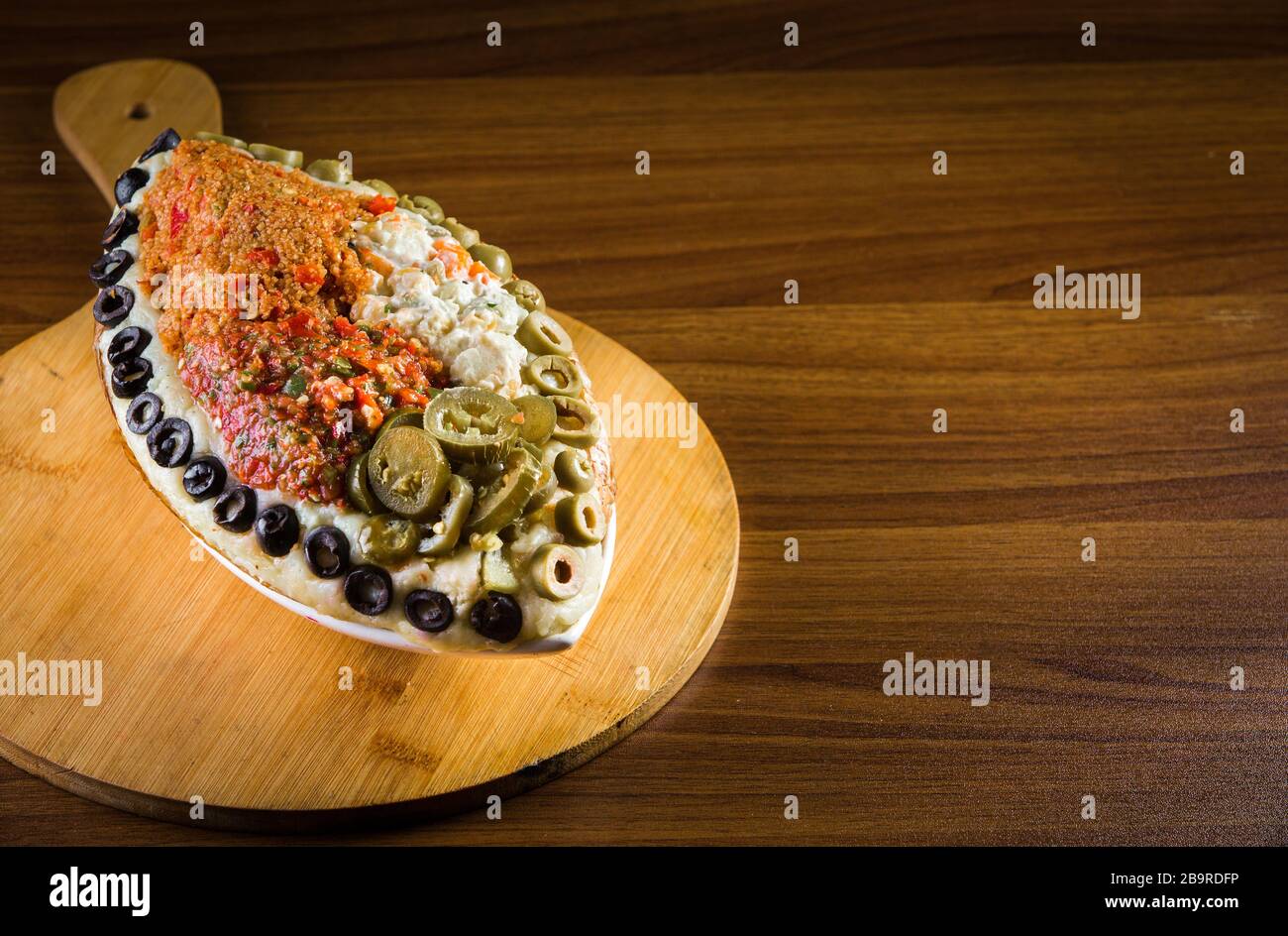 Turkish national dish called 'kumpir' which is baked potato stuffed with vegetables Stock Photo
