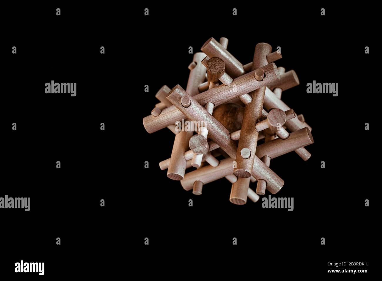 Wooden Brain Bamboo Puzzle on black background Stock Photo - Alamy