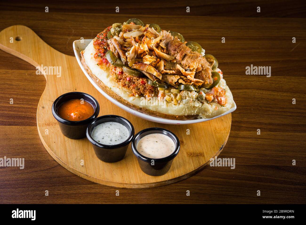 Turkish national dish called 'kumpir' which is baked potato stuffed with vegetables Stock Photo