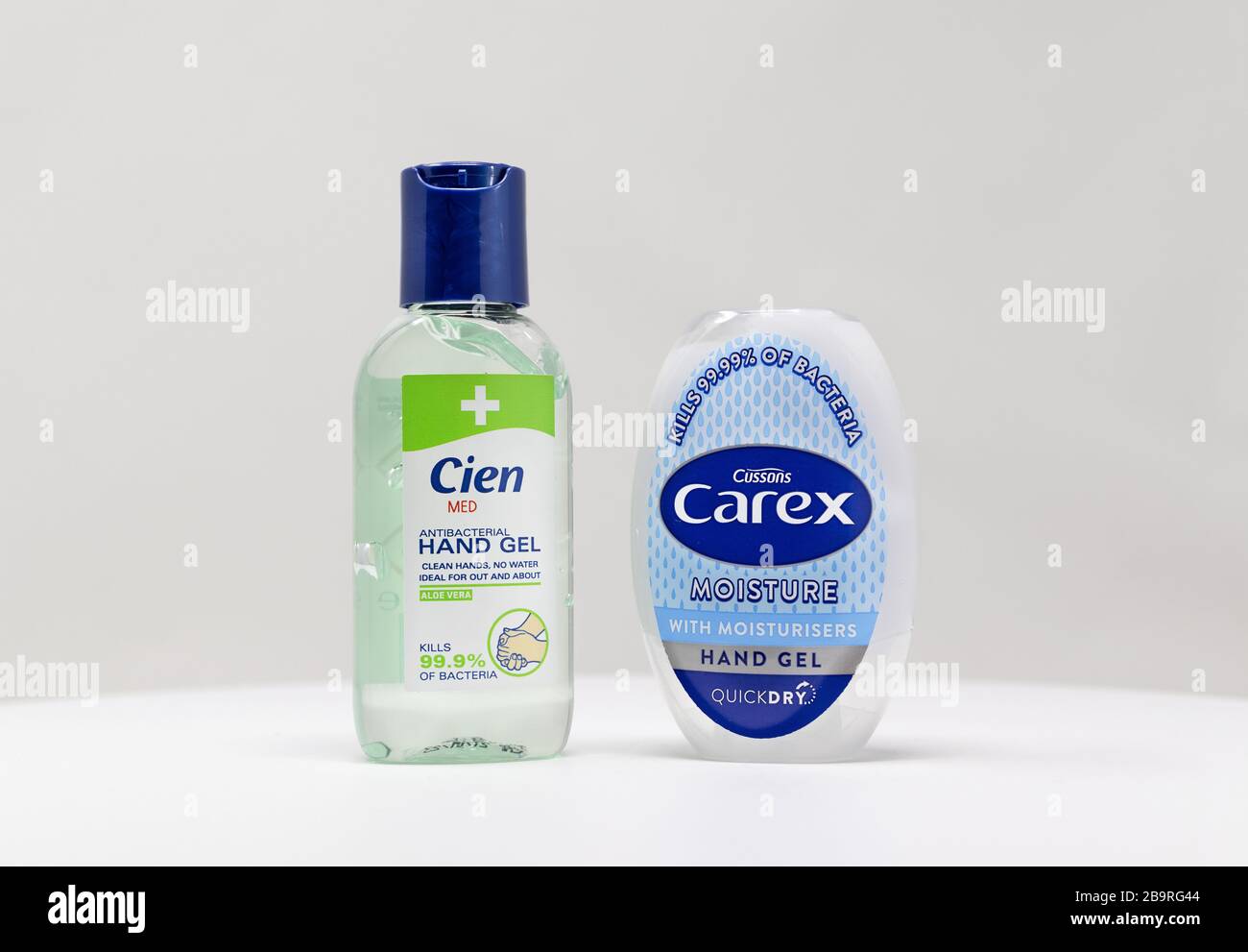 London / UK - March 22nd 2020 - Two bottles of antibacterial hand sanitiser gel from Carex and Cien brands on a white background Stock Photo