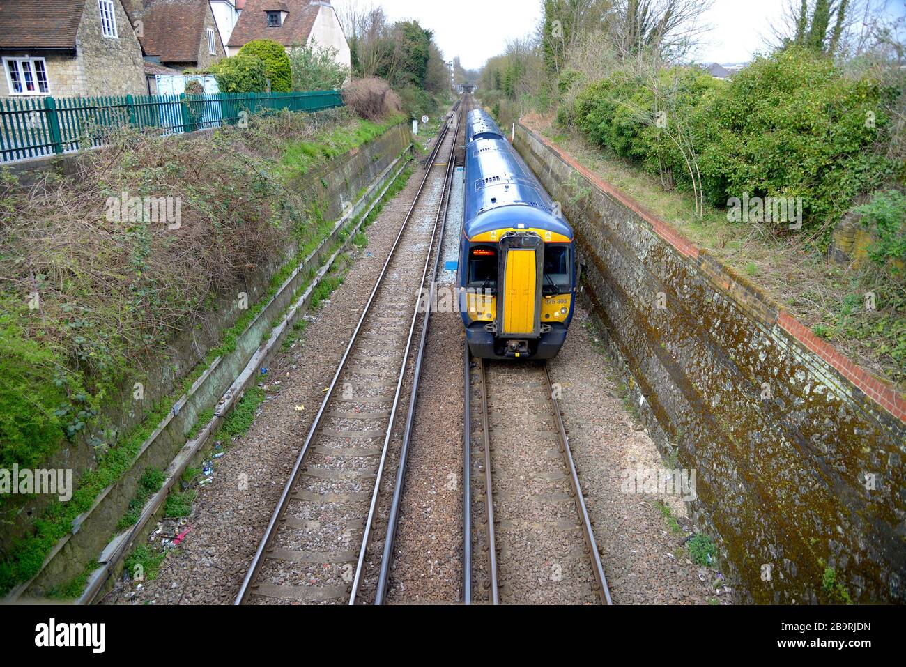 Maidstone, Kent, UK. British Rail Class 375 train passing through a cutting between Maidstone East and West stations Stock Photo