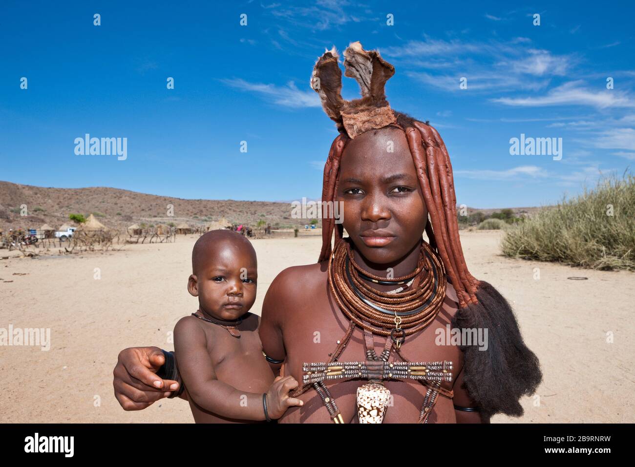 Himba Woman carrying Baby, Damaraland, Namibia Stock Photo