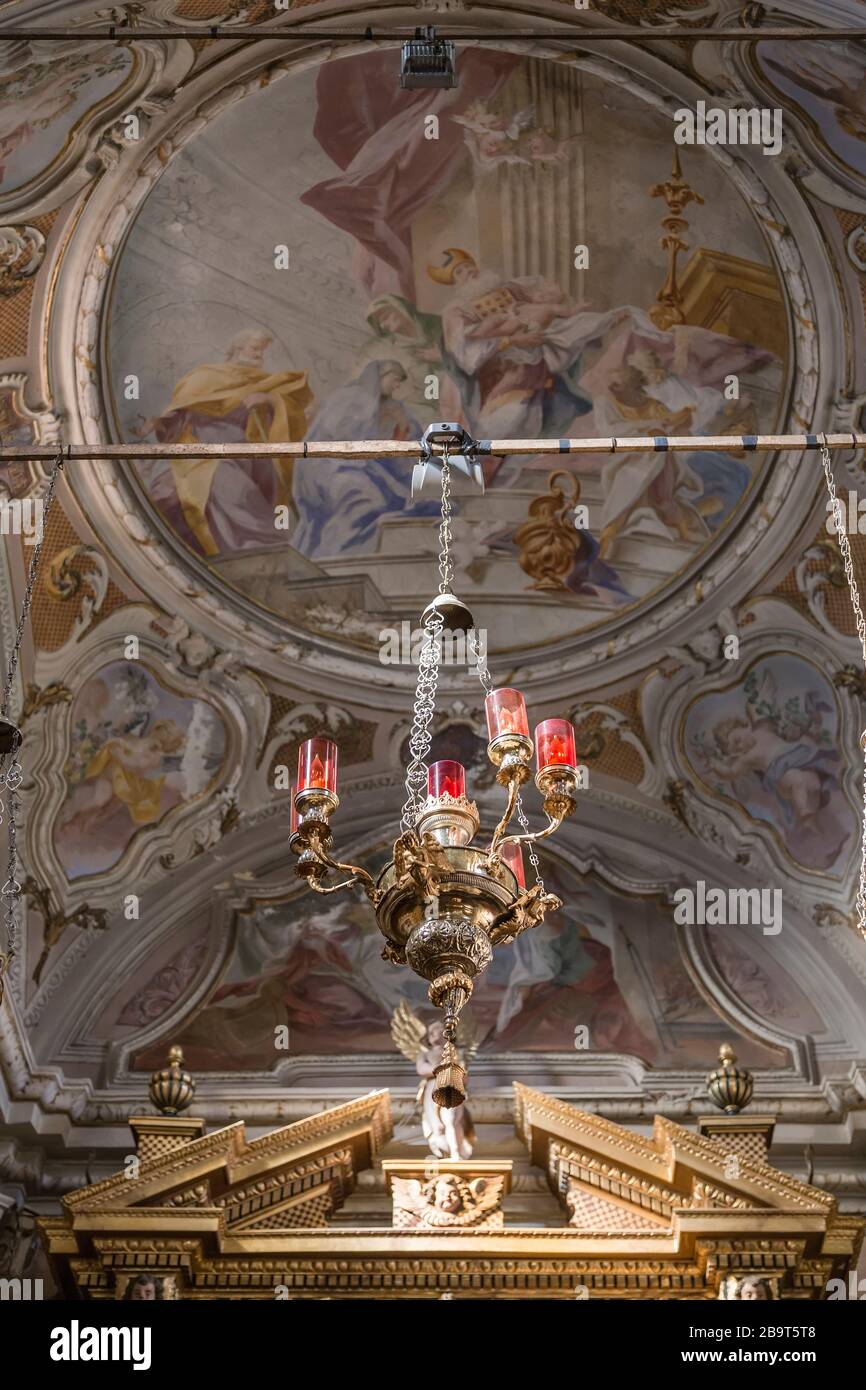 Decorative church lamp against the background of the ancient ceiling painting of the church. Monte Isola. Italy Stock Photo