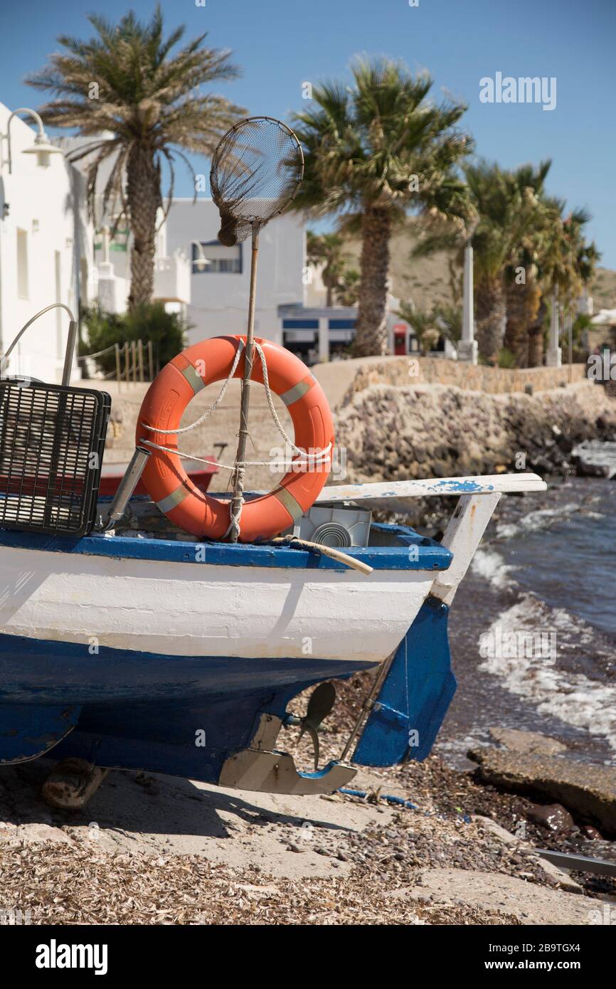 Fishing boat pulled up on the shore at Isleta del Moro, Almeria, Andalusia, Spain Stock Photo
