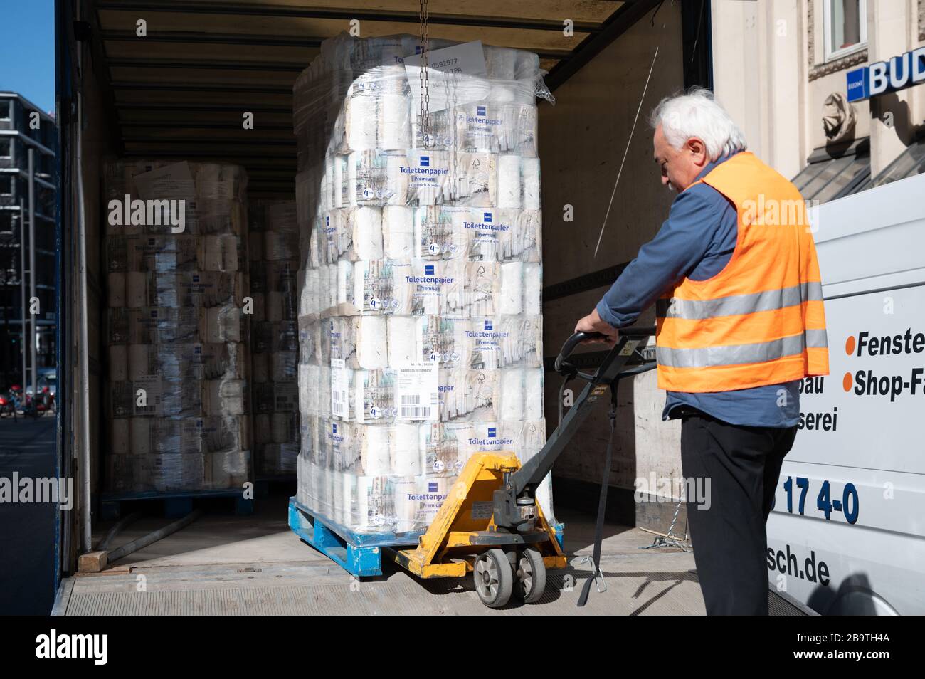 Hamburg, Germany. 25th Mar, 2020. A man delivers a pallet of toilet paper to a Budnikowsky branch. In the Corona crisis, toilet paper is still being bought by hamsters. Credit: Christophe Gateau/dpa/Alamy Live News Stock Photo