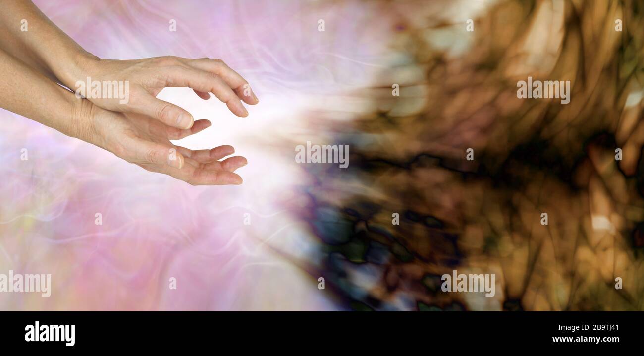 Exorcising negative entity with high resonance intention healing - female hands sending healing to neutralise and transform negative energy field Stock Photo