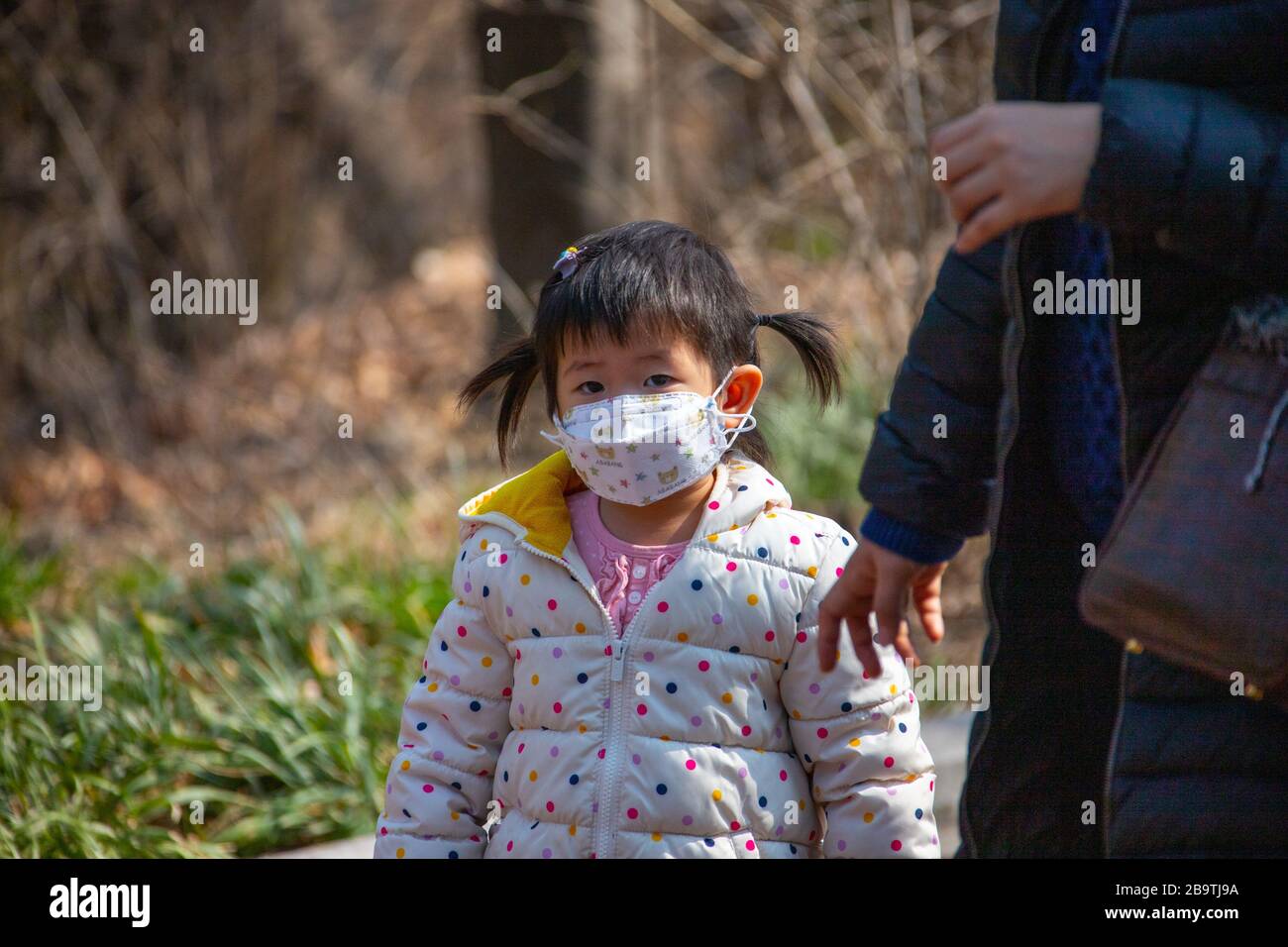 Young girl wearing a protective facemask during the Coronavirus pandemic in Seoul, South Korea, Asia Stock Photo