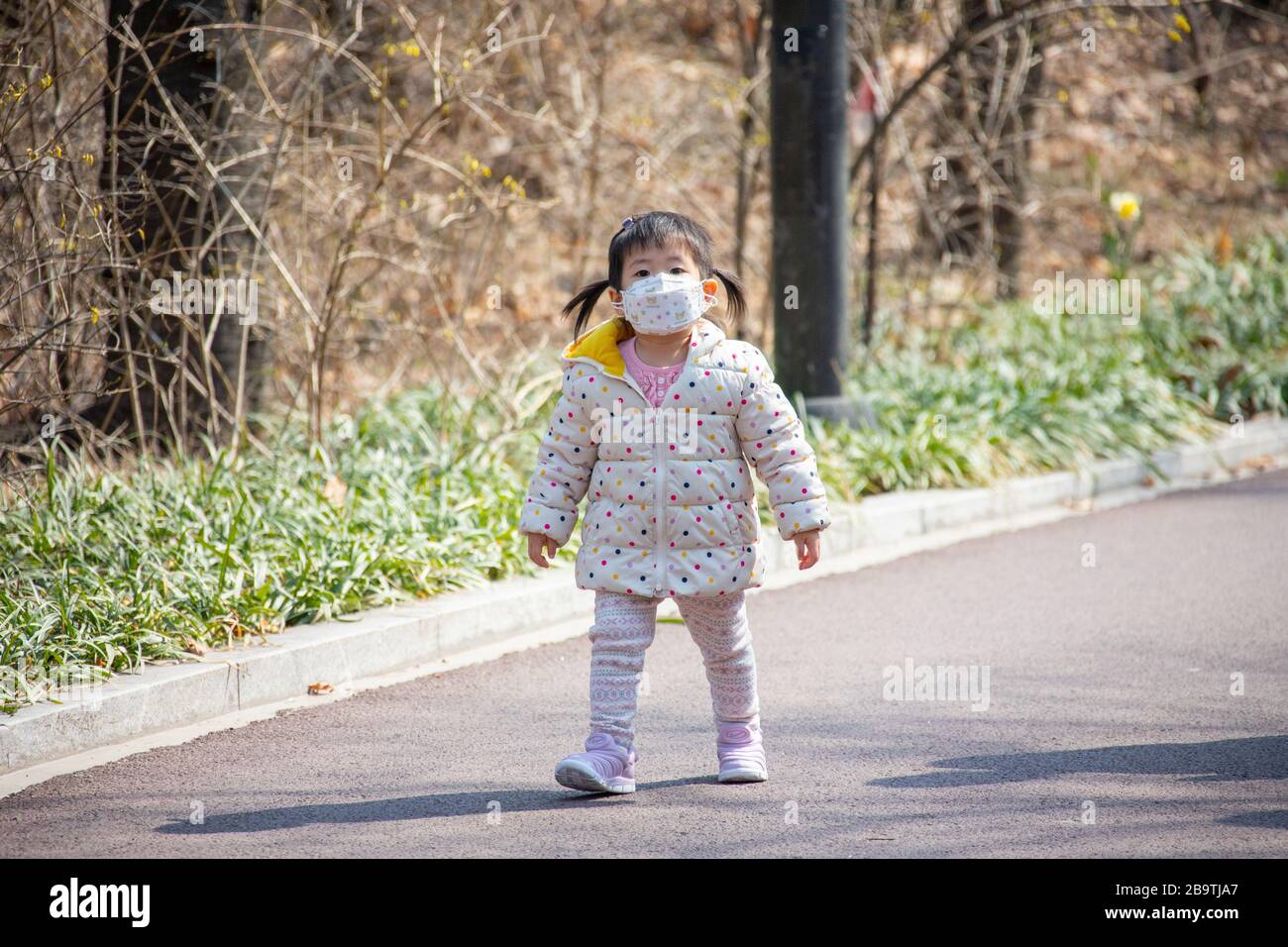 Young girl wearing a protective facemask during the Coronavirus pandemic in Seoul, South Korea, Asia Stock Photo
