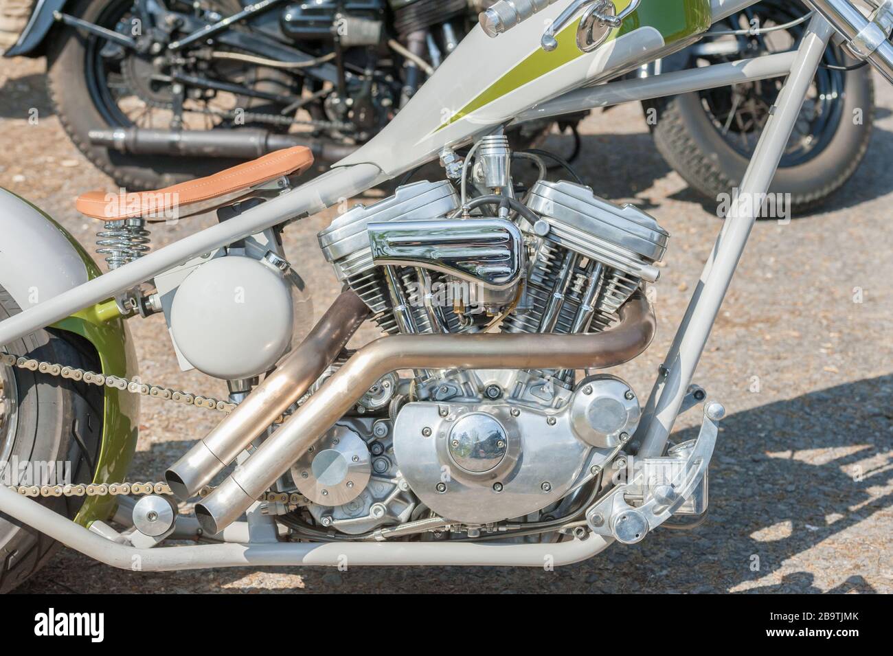 chromed custom motorcycle engine and exhaust pipe closeup Stock Photo