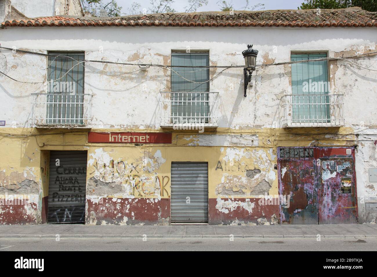 A distressed flaky facade with the word 'Internet' painted on a closed-up building on a street in Órgiva, Andalucia, Spain Stock Photo