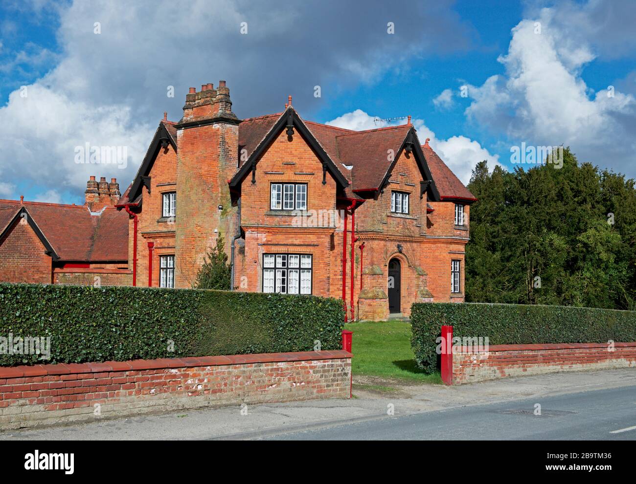 Brick estate house in the village of Sledmere, East Yorkshire, England UK Stock Photo