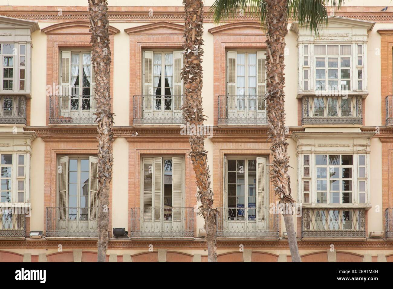 Second and third floors facade of a grand building in Plaza de la Constitución, Malaga, Andalusia, Spain Stock Photo