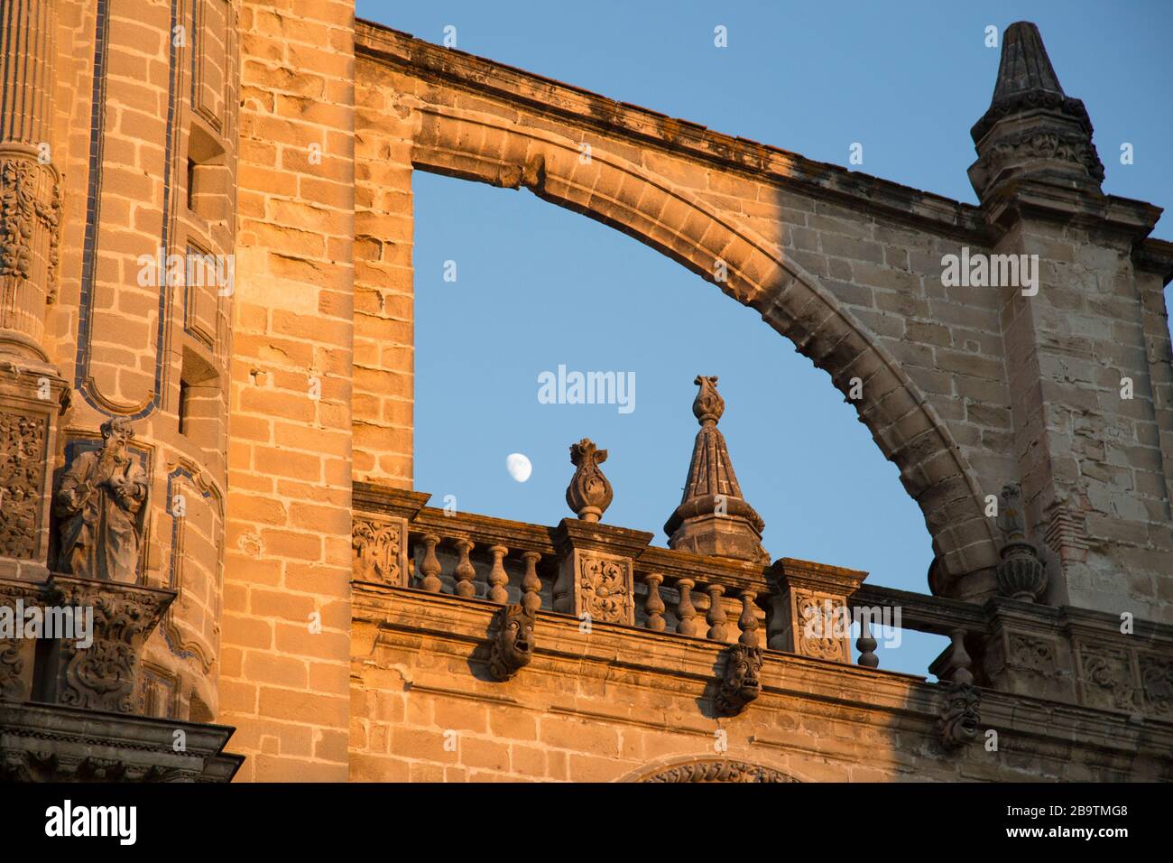 Masonry detail of an arched flying buttress, ballustrade and gargoyles on the exterior of the cathedral in Jerez de la Frontera, Andalusia, Spain. Stock Photo