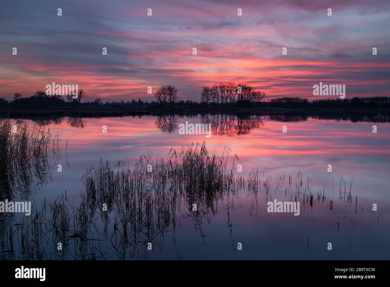 Wonderful colorful clouds over the lake after sunset Stock Photo
