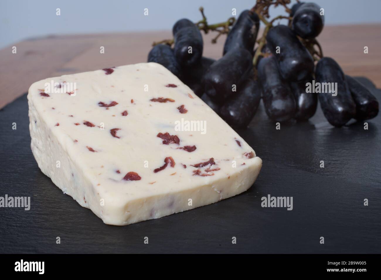 British Wensleydale cheese with long black grapes Stock Photo