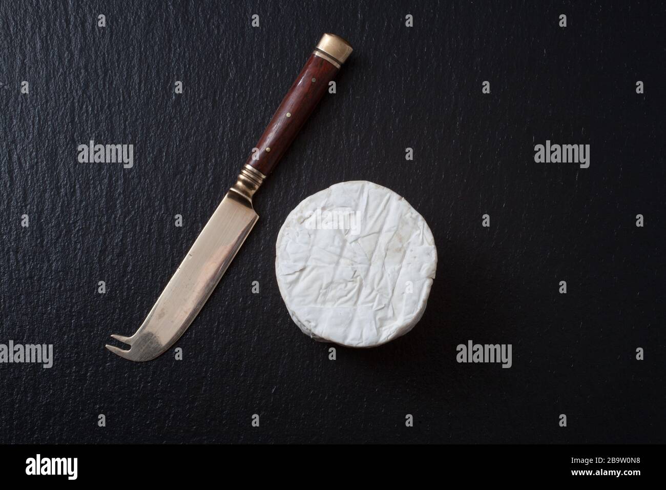 British Goat's cheese and a cheese knife Stock Photo Alamy