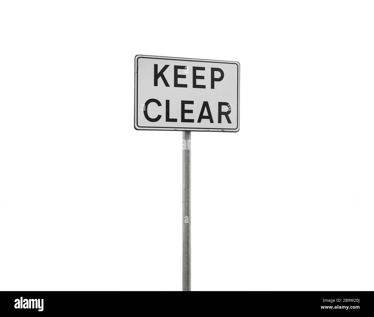 Keep clear. Caution sign on a metal pole isolated on white background Stock Photo