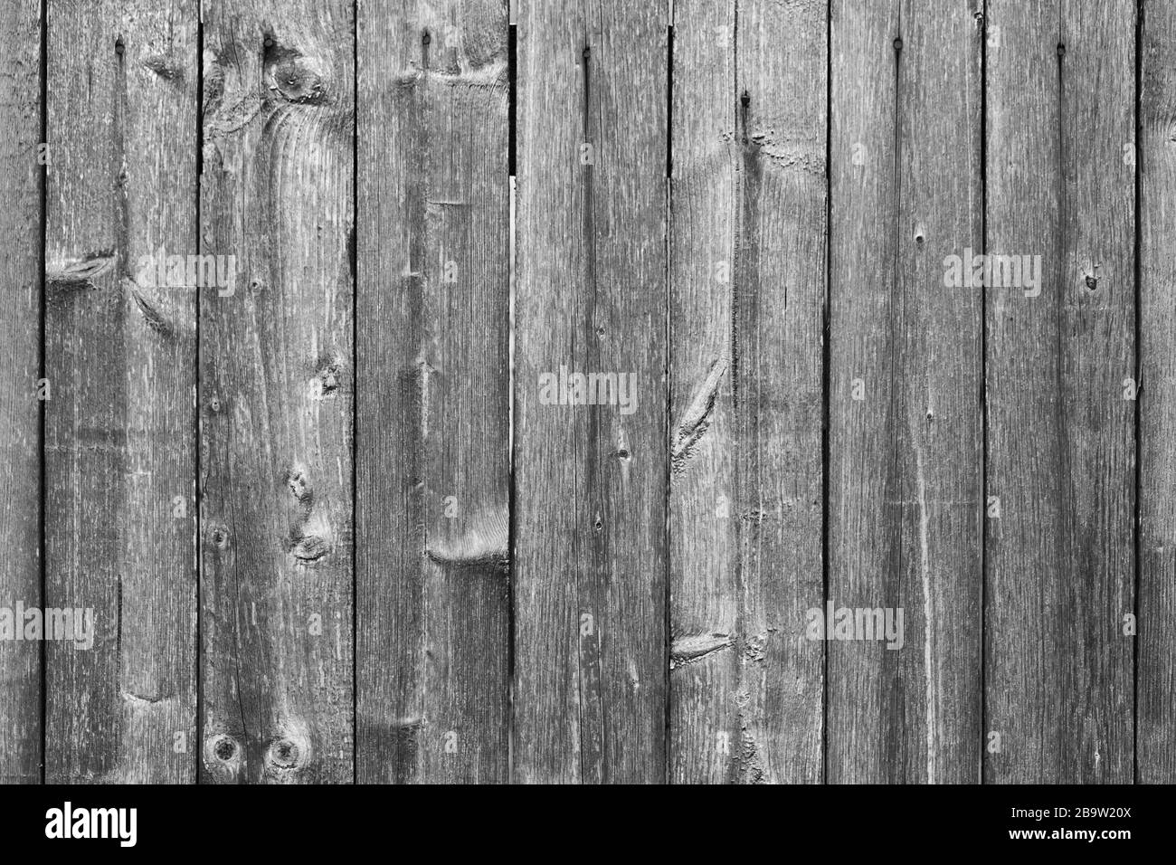 Old grungy dark gray wooden wall. Front view, background photo texture