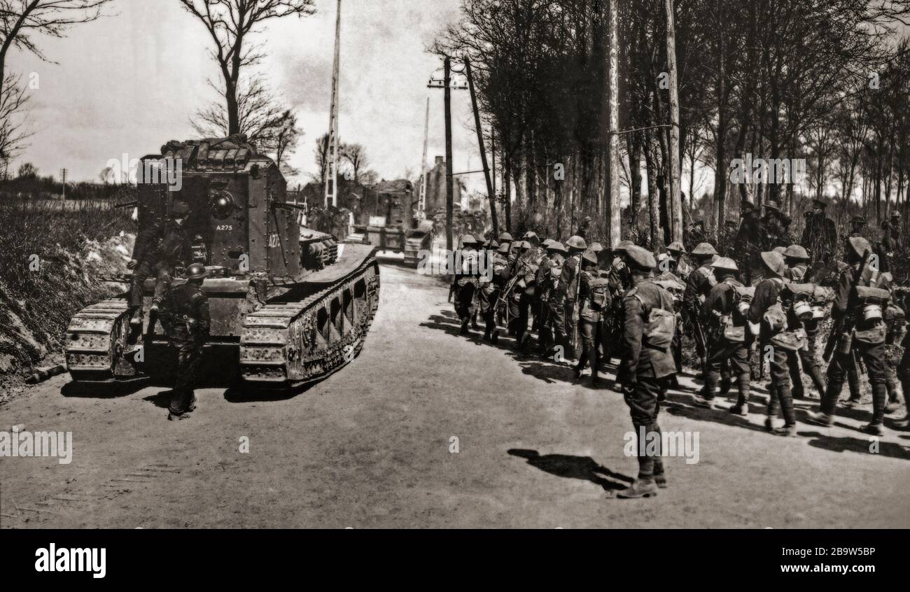 Medium Mark A 'Whippet' tanks, used for its mobility and speed in exploiting any break in the enemy lines passing New Zealand troops  at Mailly-Maillet, during Operation Michael, that began the German Spring Offensive on 21 March 1918. Stock Photo