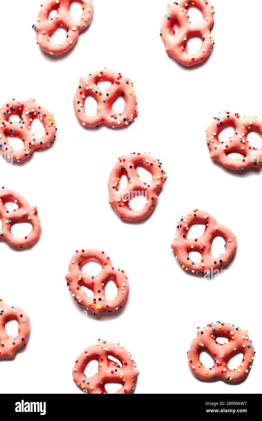 Strawberry flavoured yogurt covered pretzels on white background Stock