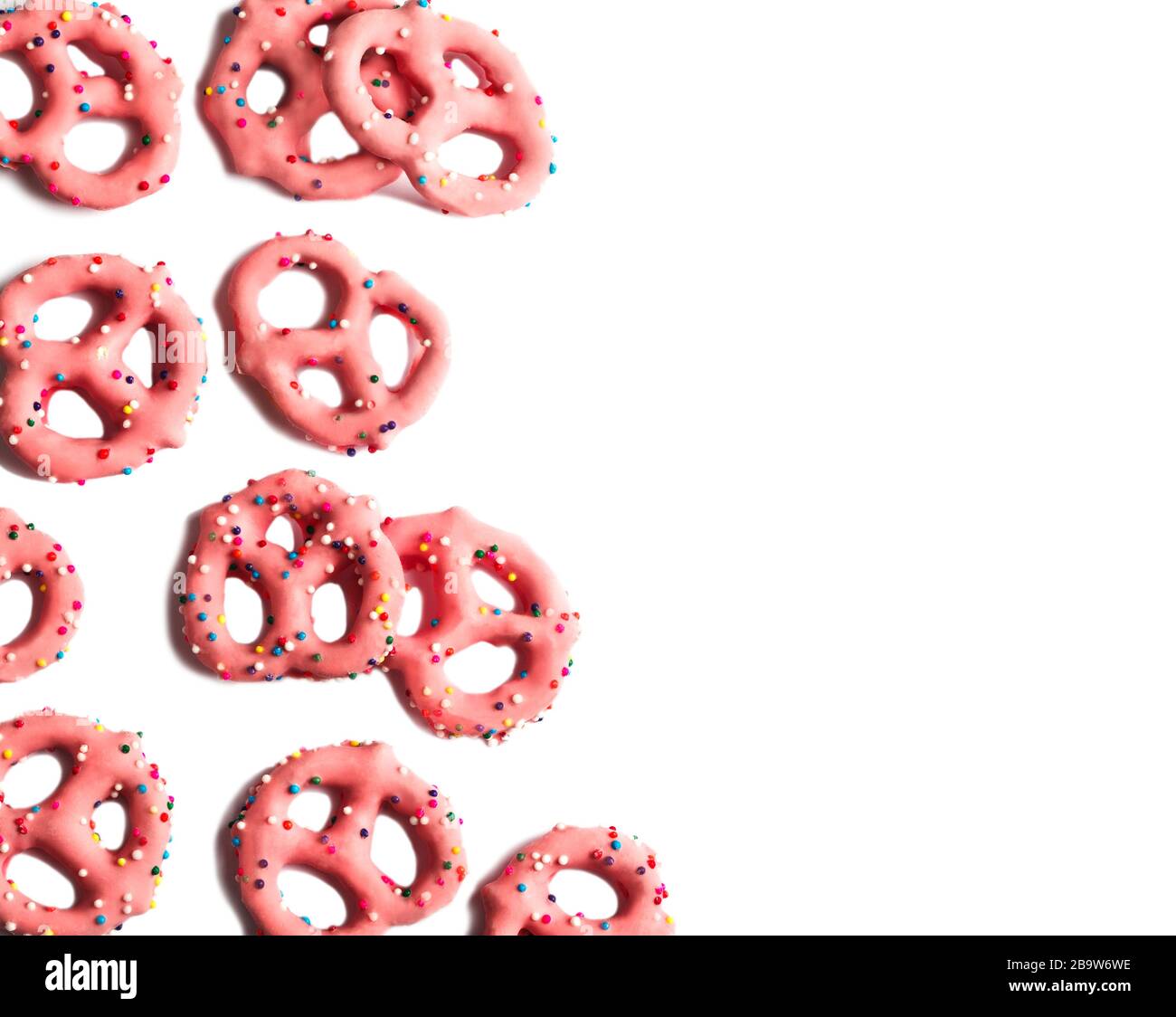 Strawberry flavoured yogurt covered pretzels on white background, copy