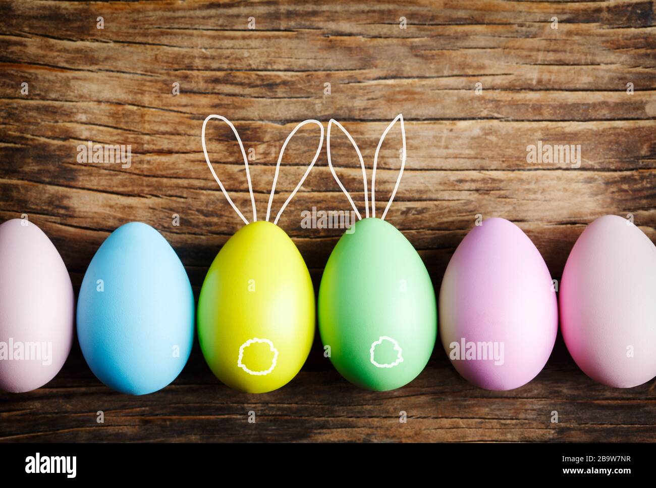 Easter eggs cute bunny. Easter eggs decoration on wooden background. Easter background with copy space Stock Photo