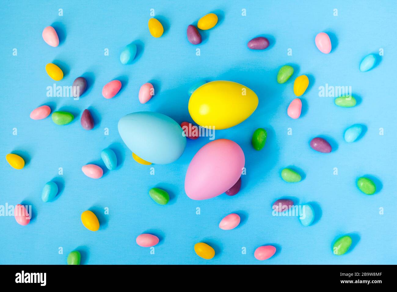 Easter decoration eggs and candy on blue background. Easter background Stock Photo