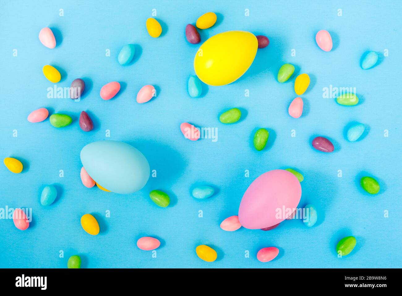 Easter decoration eggs and candy on blue background. Easter background Stock Photo