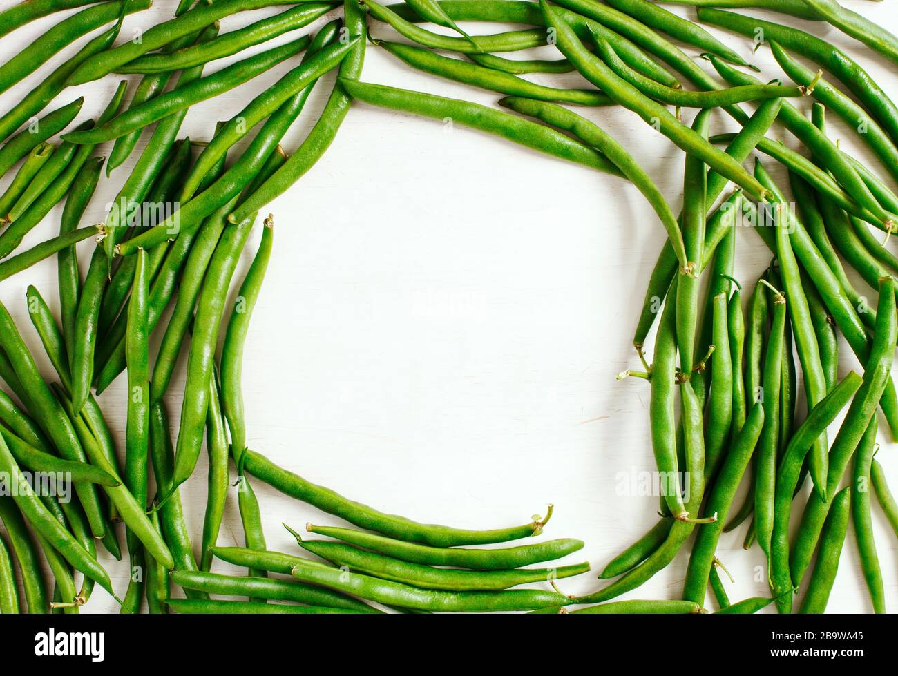 Green beans on white background, frame, copy sapce, top view. Stock Photo