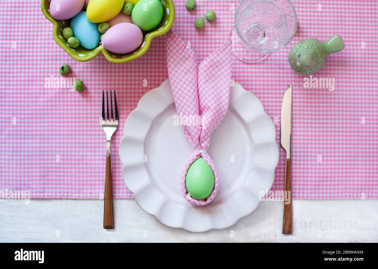 Festive Easter table setting with napkin Easter Bunny, top view. Stock Photo