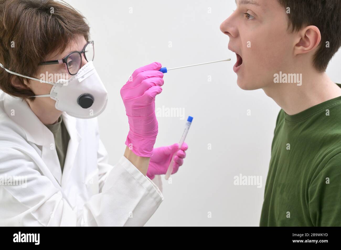 Doctor Collecting with a nasopharyngeal nose and throat swab Stock Photo