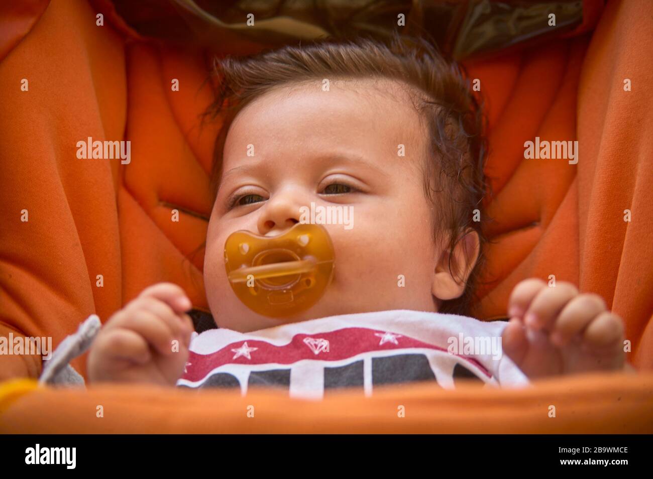 Baby with the pacifier in the stroller Stock Photo Alamy