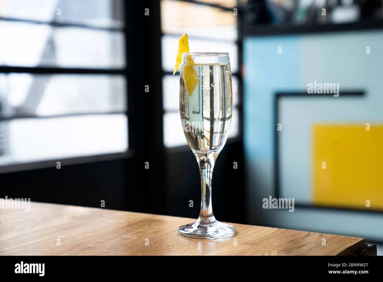 Glass of fizzy white wine in a trendy bar. Stock Photo