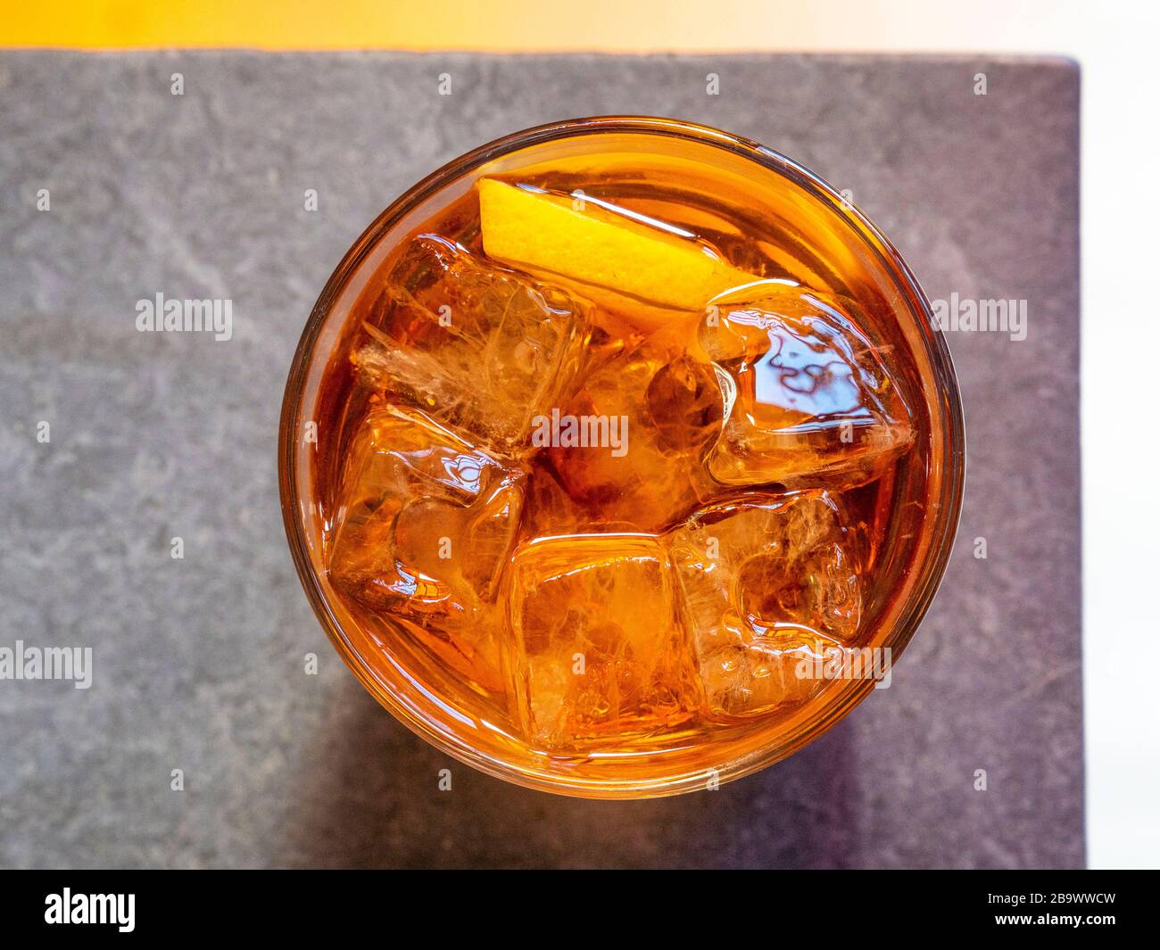 Old Fashioned cocktail in sunlit trendy bar. Stock Photo