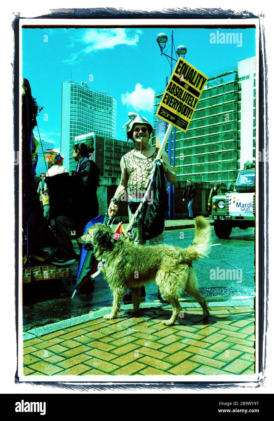 Marcher and dog at Birmingham Pride parade, cross processed film image Stock Photo