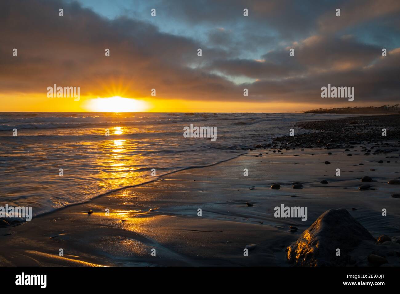 Beautiful scenery of the sunset reflecting on the sea Stock Photo - Alamy
